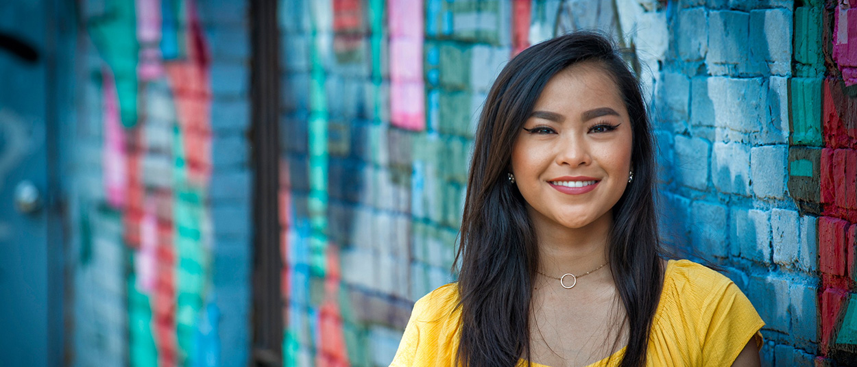 Student portrait against colorful wall